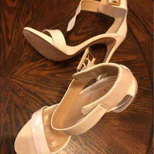 Pair of white leather open toe ankle strap heels