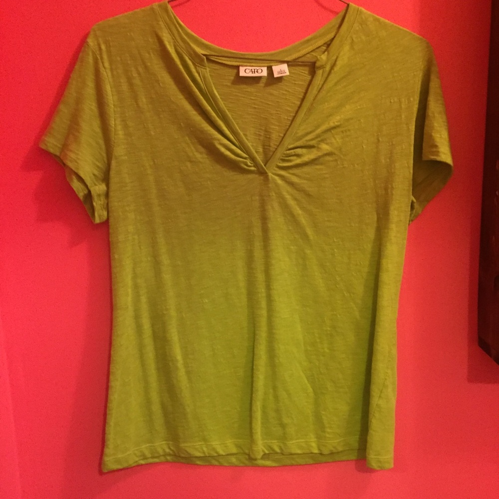 Large green V neck shirt.