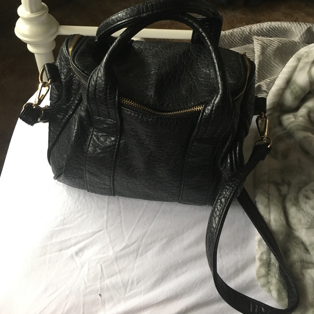 Black purse with gold studs on the bottom