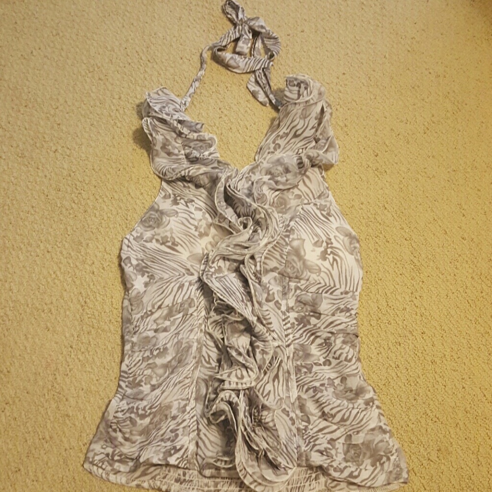 Tie around the neck ruffle flutter satin top.