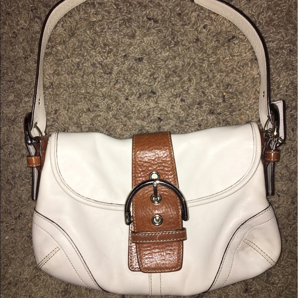 Small shoulder brown and white leather coach bag.
