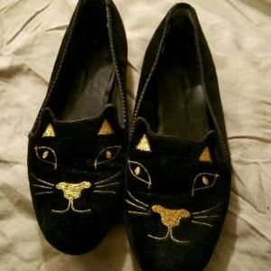 Black velvet loafers featuring gold cat face