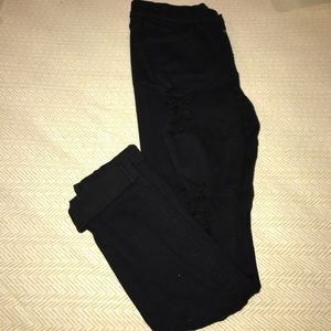 Distressed Black mid rise skinny leggings.