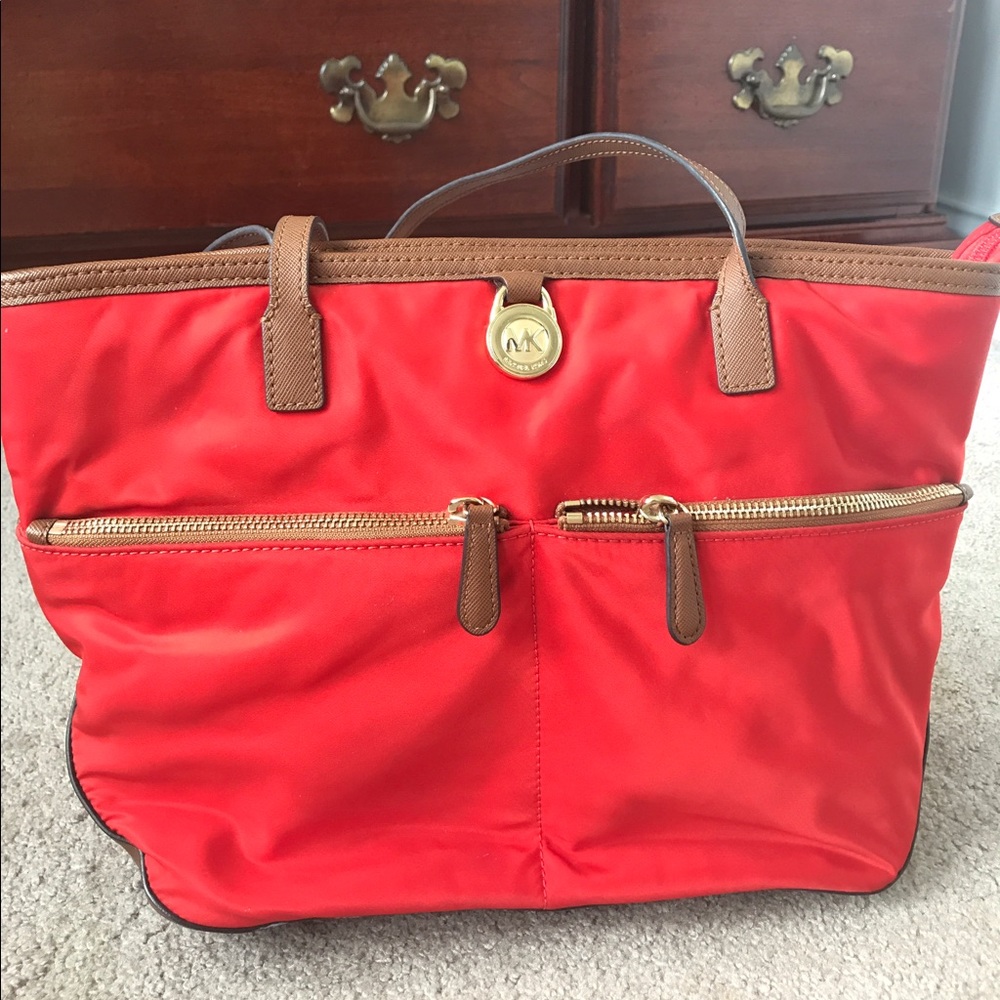 Michael Kohrs red tote purse with magenta interior
