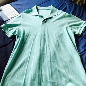 Teal colored polo shirt.