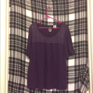 Purple shirt. Fits like a 1X, but there is no tag.