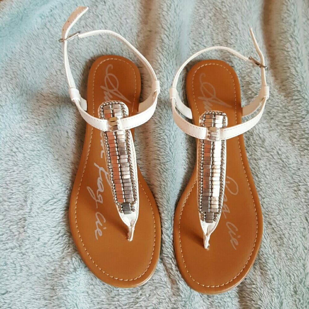 White sandals with metal detailing