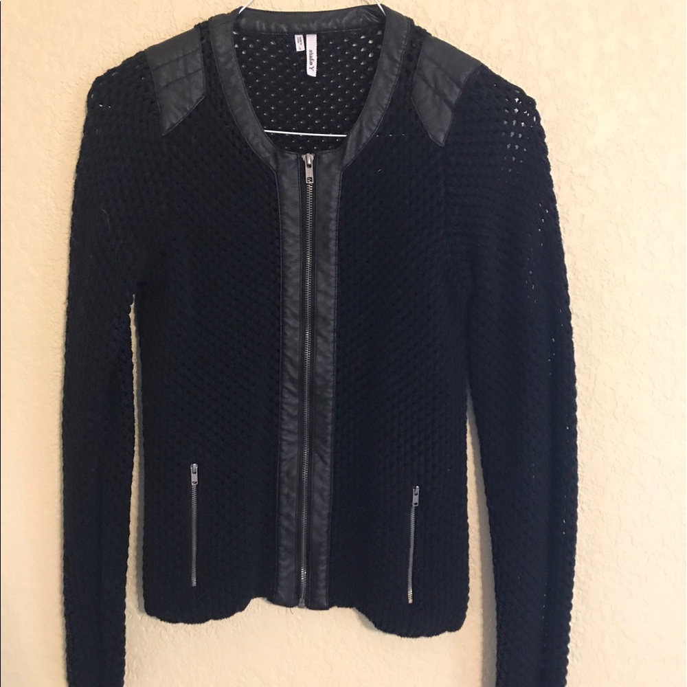 Black sweater with leather details.