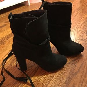 Black heeled booties with straps to tie
