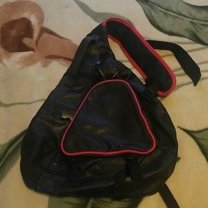 One shoulder black and red trim leather backpack.