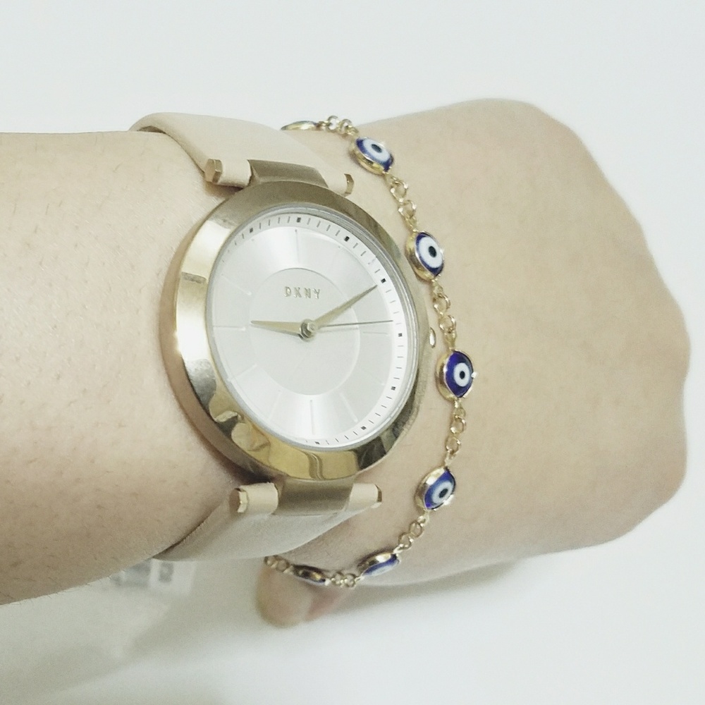 DKNY gold tone with caramel/tan color strap
