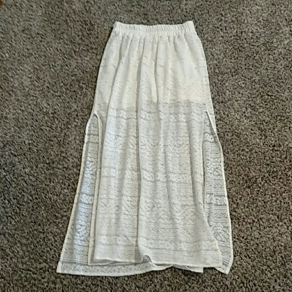 White lace skirt with leg slits.