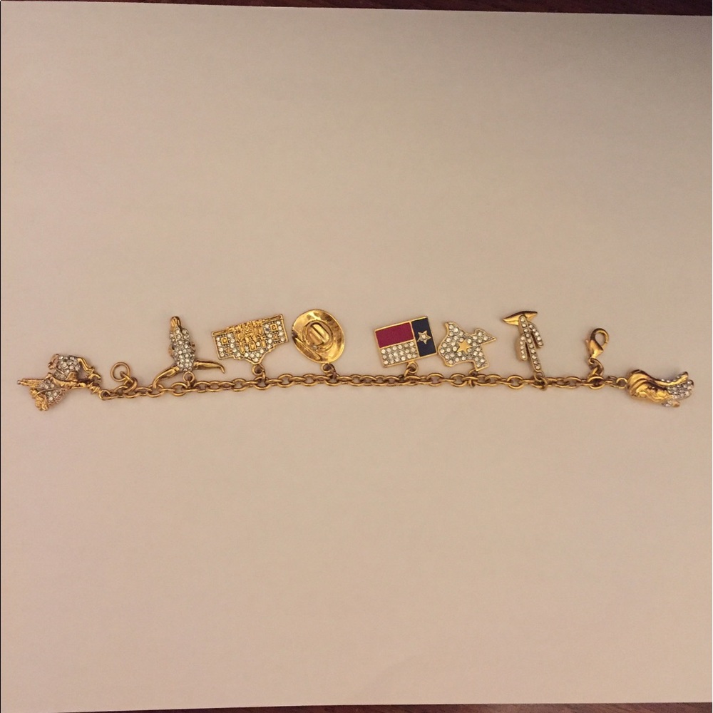 Nice Gold Tone charm bracelet has 8 charms.