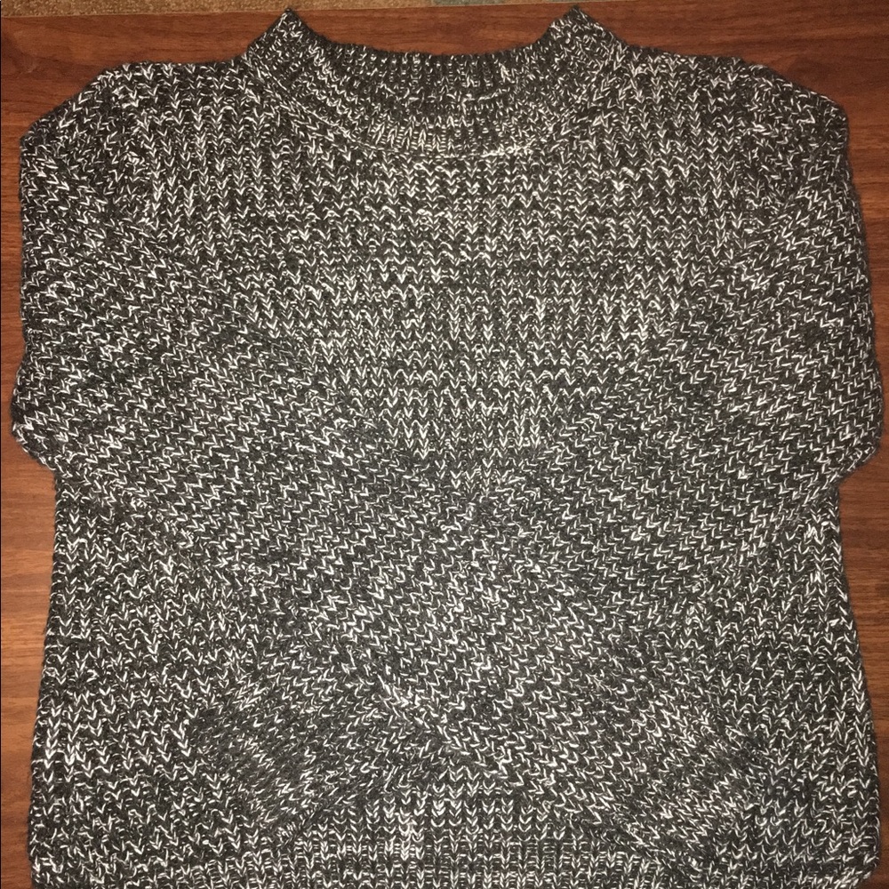 Grey long sleeved crew neck sweater.