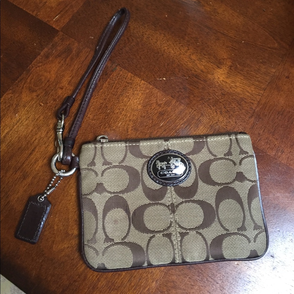 Light brown Coach wristlet.