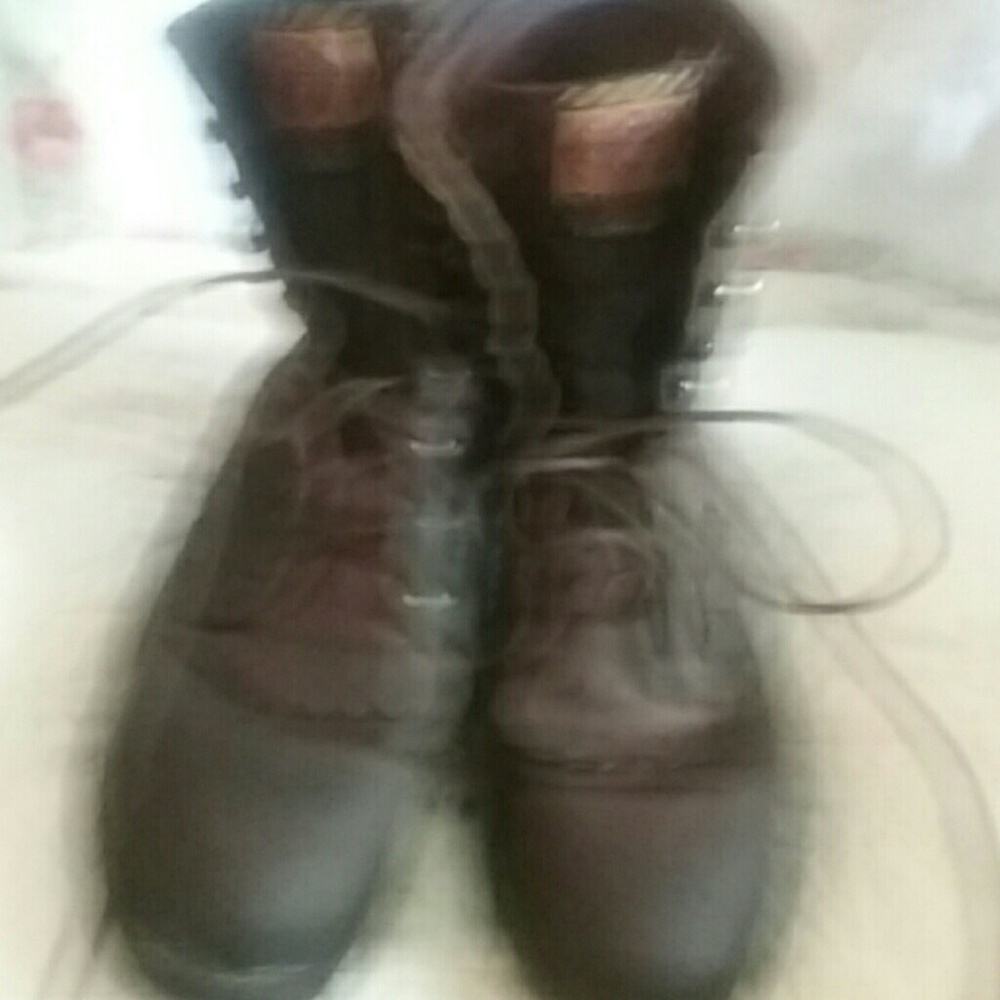 Brown lace up Justin boots.
