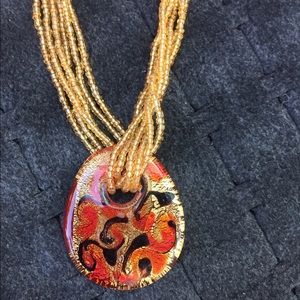 Gold beaded necklace with pendant