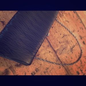 Black textured fabric clutch w/ crystal closure.