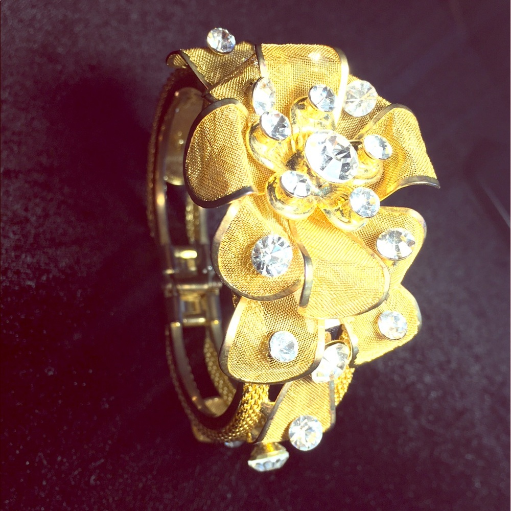 Gold statement piece with floral detail.