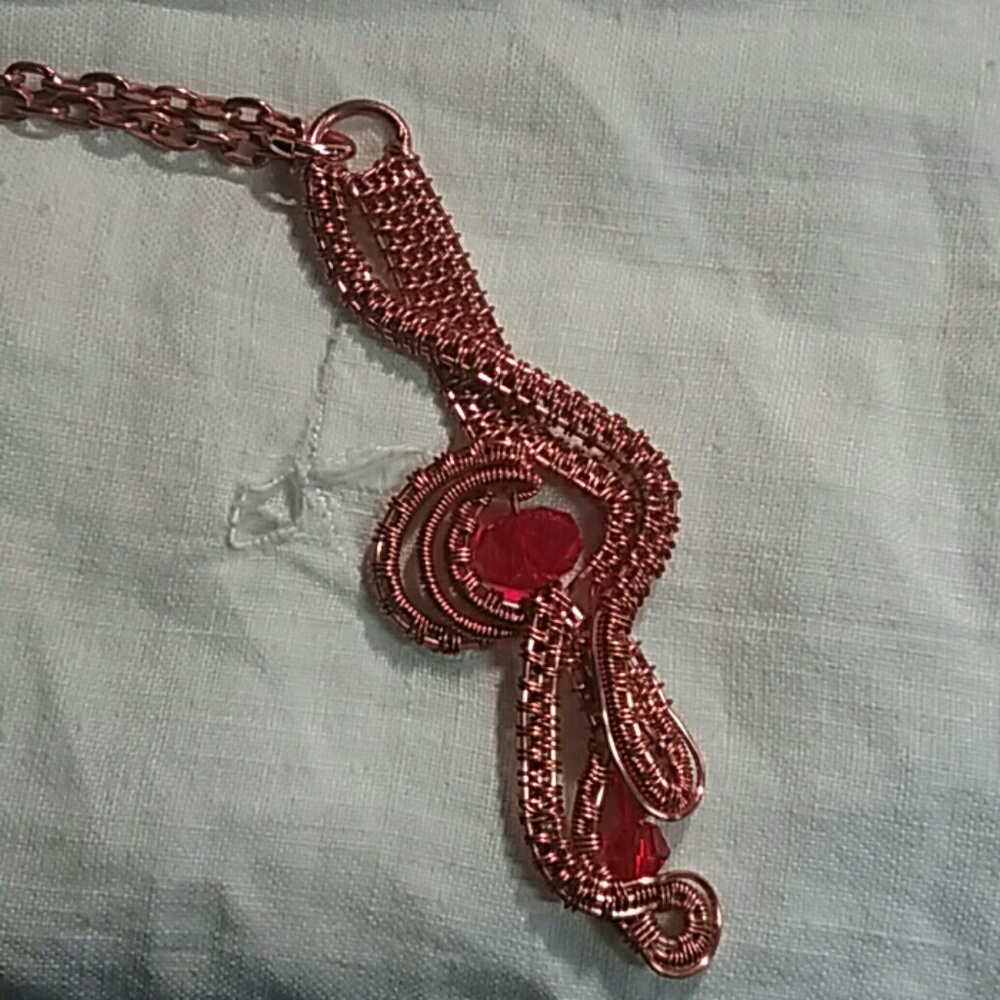 Red Swarovski crystals in copper wire weave