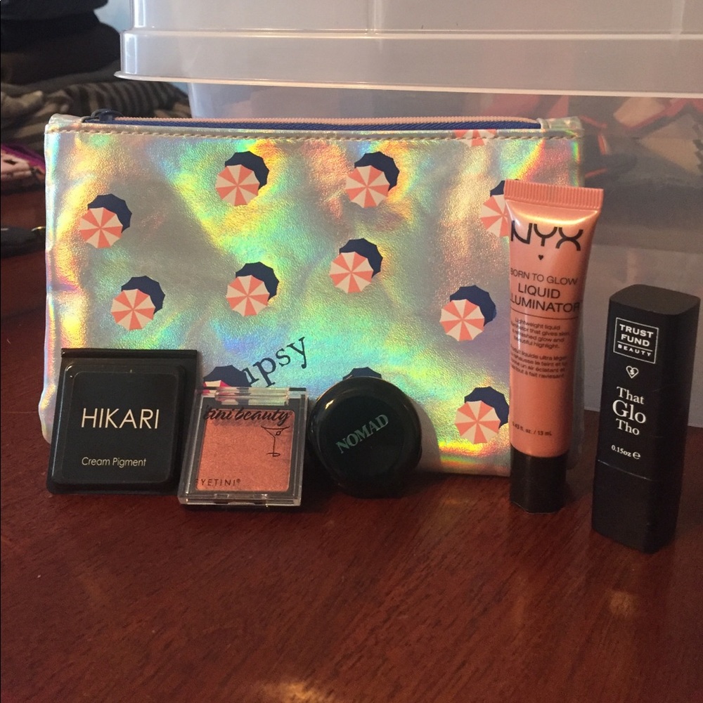 Ipsy bag with eyeshadow and highlighter samples
