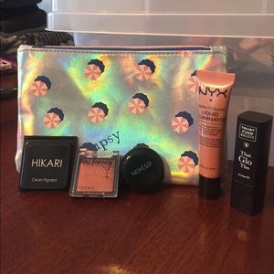 Ipsy bag with eyeshadow and highlighter samples