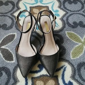 Elegant black and metallic strappy heels