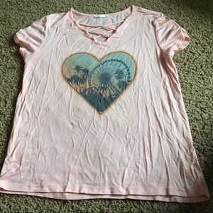 A light pink shirt with a heart in the center.