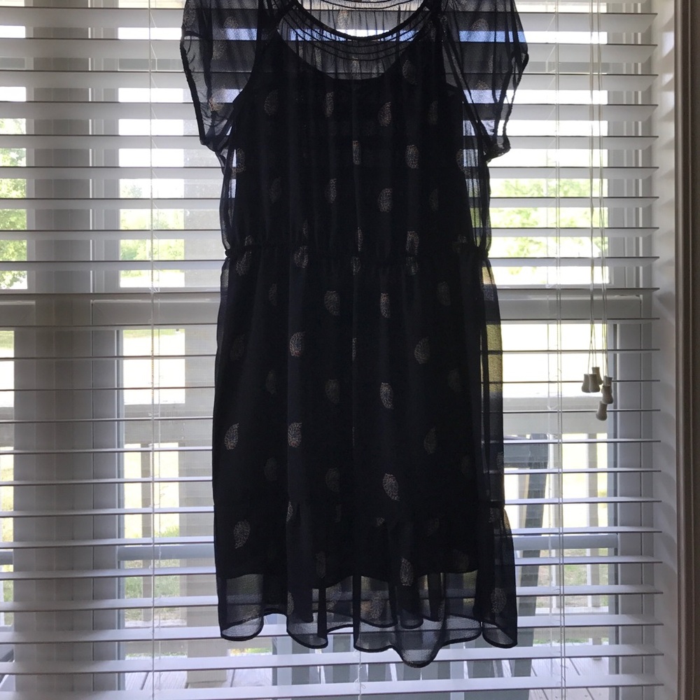 Navy dress with designs on it.