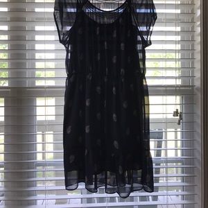 Navy dress with designs on it.