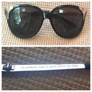 Oversized sunglasses with supportive text
