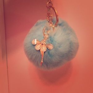 A Pom Pom with an extra key chain on it