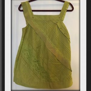 Cotton sleeveless top with intricate details.