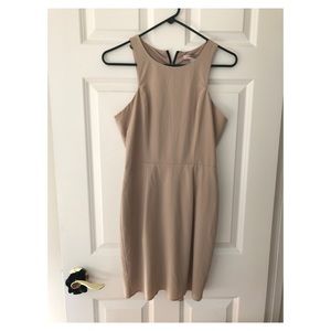 Nude fitted dress with black zipper accent
