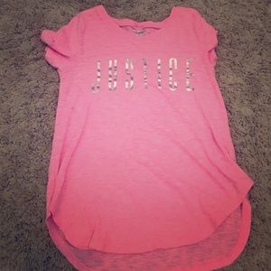A pink shirt that says justice