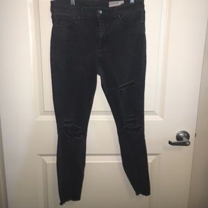 Black worn looking ripped jeans