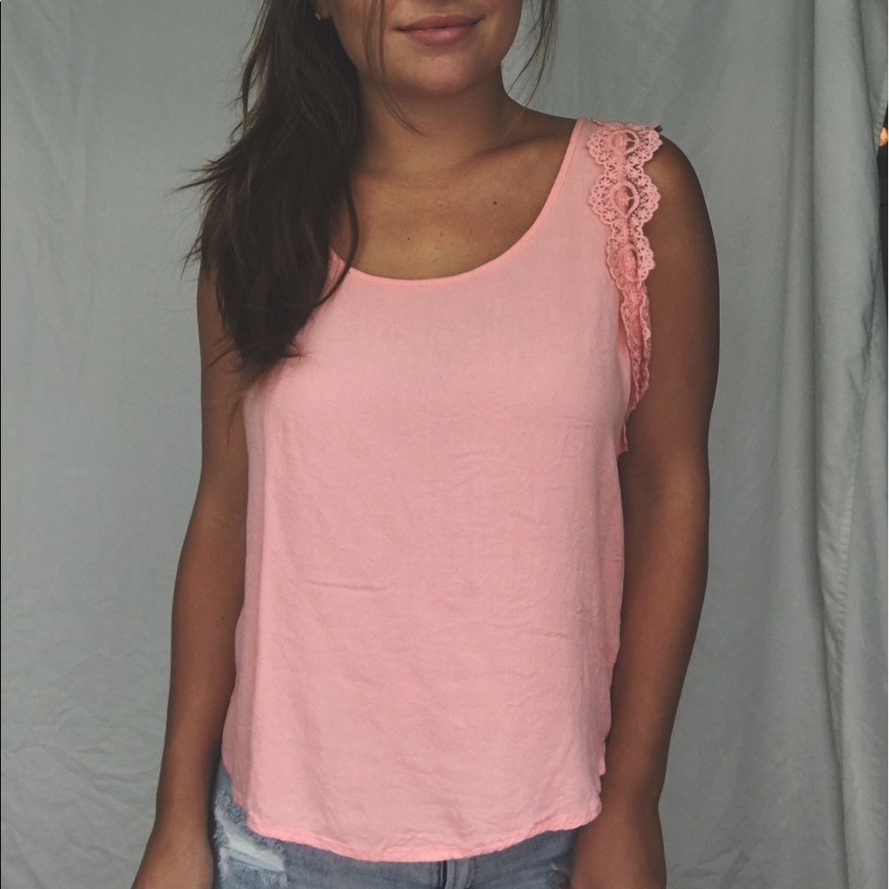 Peach top with details around the sleeve