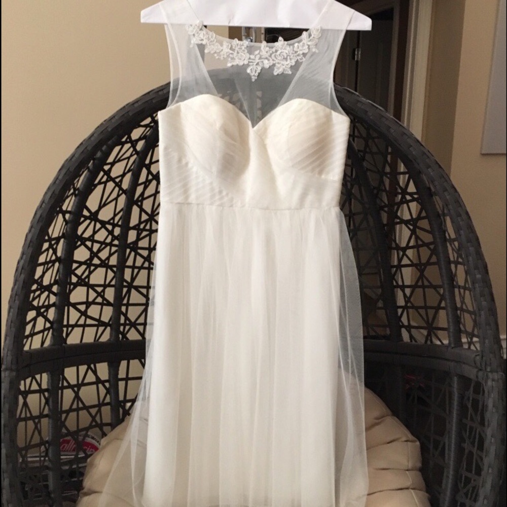 White dress with intricate lace neckline detail