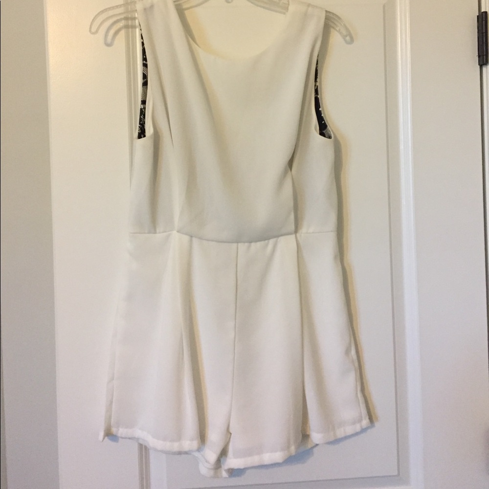 White open back romper with black lace