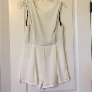 White open back romper with black lace