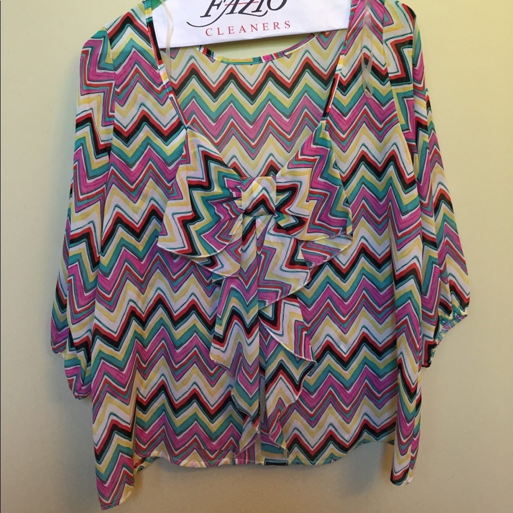 Colorful blouse with deep back and bow accent