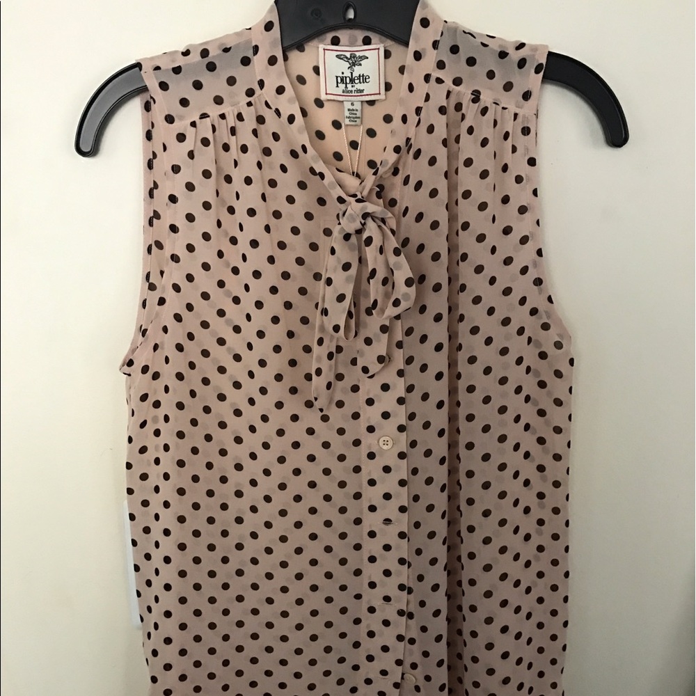 Polka dot sleeveless button down.