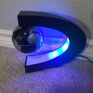 LED magnetic world globe, floats with white stick.