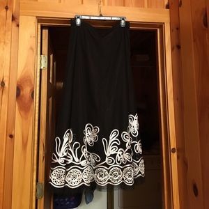 Black maxi skirt with white trim.