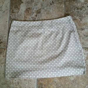 Very cute tan mini skirt, white diamond print