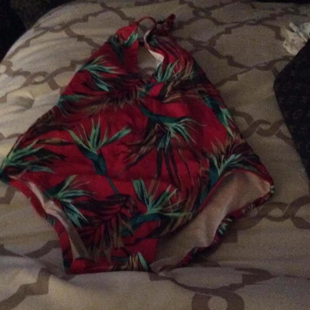 Pink one piece swimsuit, tropical print.