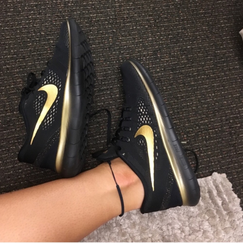 Black & gold Nike free runs