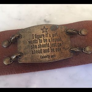 Leather wrist cuff with antiqued brass sentiment.