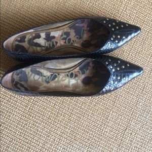 Black pointy flats with gold detail