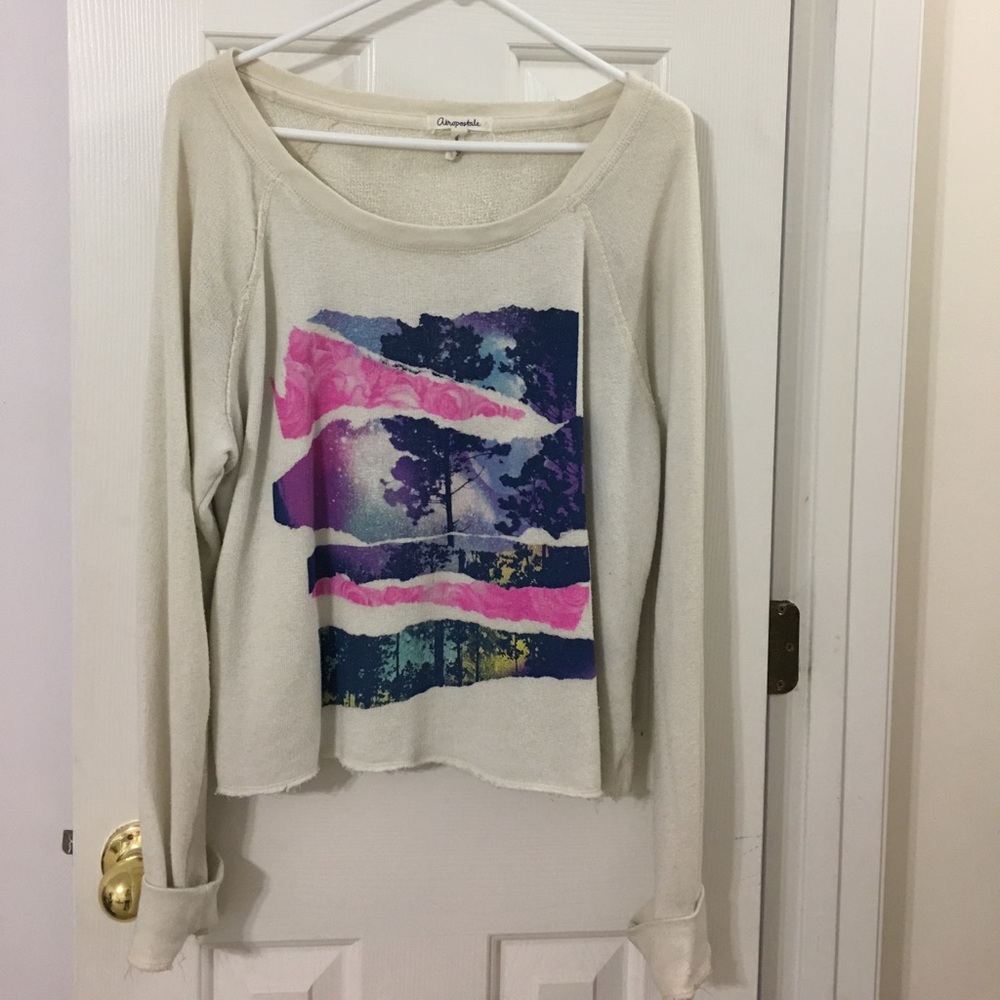 A cropped light sweater